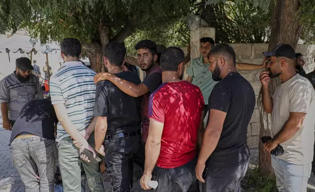 Young Kurdish men line up to sign up to join Syrian government's General Security forces at a police station in Afrin, Syria, an area in the country's north from which Kurds were forcibly displaced years ago, Thursday Aug. 21, 2025. (AP Photo/Omar Albam)