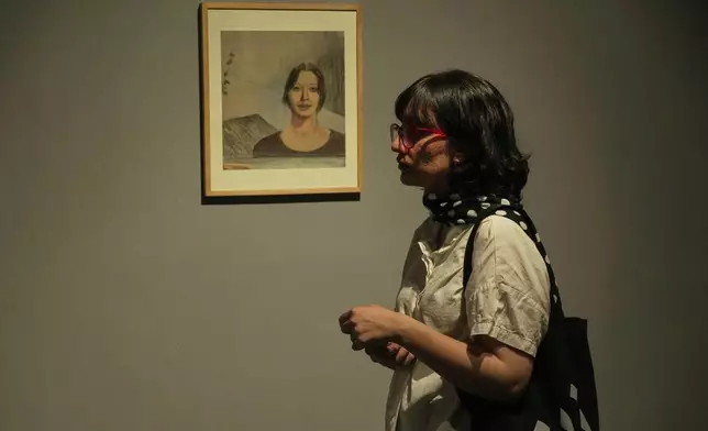 A woman visits an exhibition called "In Women's Words" showing some artworks of modern Iranian women artists from the collection of the Tehran Museum of Contemporary Art, Iran, Sunday, Aug. 3, 2025. (AP Photo/Vahid Salemi)