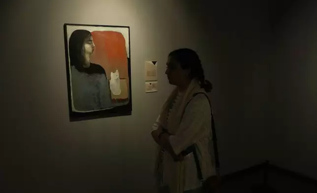 A woman visits an exhibition called "In Women's Words" showing some artworks of modern Iranian women artists from the collection of the Tehran Museum of Contemporary Art, Iran, Sunday, Aug. 3, 2025. (AP Photo/Vahid Salemi)