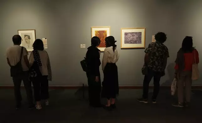 People visit an exhibition called "In Women's Words" showing some artworks of modern Iranian women artists from the collection of the Tehran Museum of Contemporary Art, Iran, Sunday, Aug. 3, 2025. (AP Photo/Vahid Salemi)