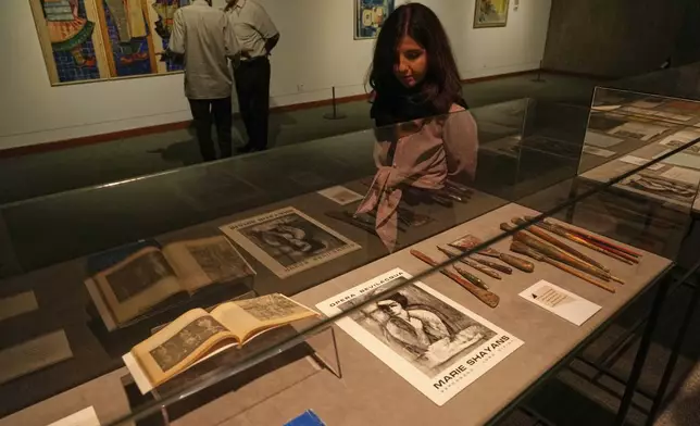 A woman visits an exhibition called "In Women's Words" showing some artworks of modern Iranian women artists from the collection of the Tehran Museum of Contemporary Art, Iran, Sunday, Aug. 3, 2025. (AP Photo/Vahid Salemi)
