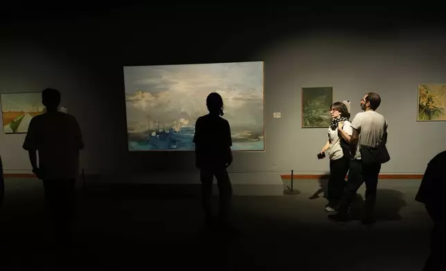 People visit an exhibition called "In Women's Word" showing some artworks of modern Iranian women artists from the collection of the Tehran Museum of Contemporary Art, Iran, Sunday, Aug. 3, 2025. (AP Photo/Vahid Salemi)