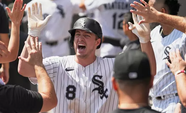 Chicago White Sox's Kyle Teel celebrates with teammates after scoring on a two-run single by Edgar Quero during the first inning of a baseball game against the Minnesota Twins in Chicago, Sunday, Aug. 24, 2025. (AP Photo/Nam Y. Huh)