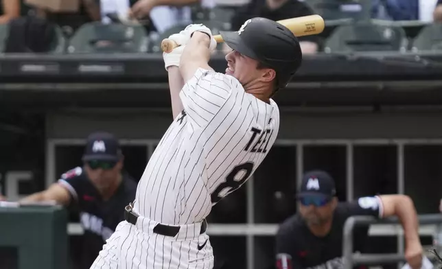 Chicago White Sox's Kyle Teel hits a one-run single during the first inning of a baseball game against the Minnesota Twins in Chicago, Sunday, Aug. 24, 2025. (AP Photo/Nam Y. Huh)