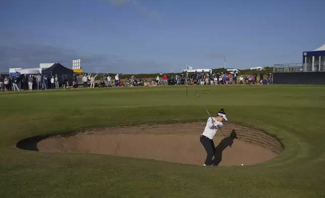 Miyu Yamashita of Japan chips out of a bunker on the 17th green during the third round of the Women's British Open golf championship, at Royal Porthcawl Golf Club in Porthcawl, Wales, Saturday, Aug. 2, 2025. (AP Photo/Kin Cheung)