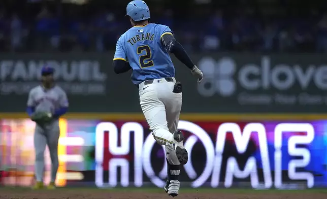 Milwaukee Brewers' Brice Turang rounds the bases after hitting a two-run home run during the fifth inning of a baseball game against the New York Mets, Friday, Aug. 8, 2025, in Milwaukee. (AP Photo/Aaron Gash)