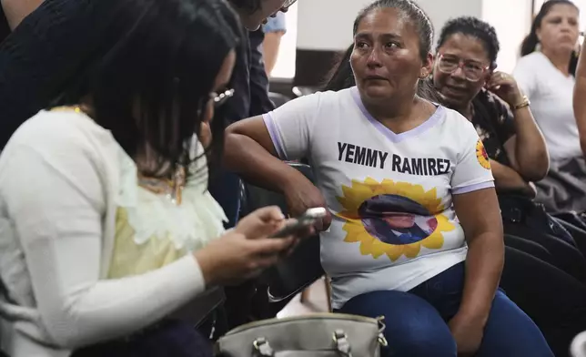 Elsa Siquin, right, wears a T-shirt with a portrait of her daughter, Yemmy Ramirez, one of 41 girls killed in a fire at a government-run facility for at-risk girls in 2017, during a hearing for those accused of responsibility in Guatemala City, Tuesday, Aug. 12, 2025. (AP Photo/Moises Castillo)