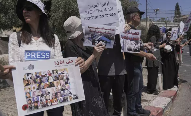 Palestinian and Israeli activists and journalists take part in a protest against the killing of Palestinian journalists in the Gaza Strip, as they gather in Nazareth, Israel, Friday, Aug. 29, 2025. (AP Photo/Mahmoud Illean)