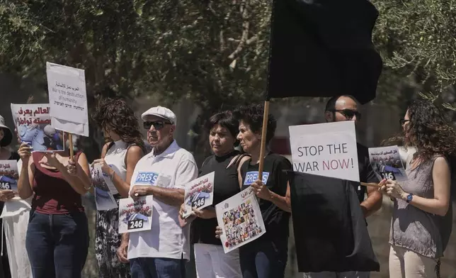Palestinian and Israeli activists and journalists take part in a protest against the killing of Palestinian journalists in the Gaza Strip, as they gather in Nazareth, Israel, Friday, Aug. 29, 2025. (AP Photo/Mahmoud Illean)