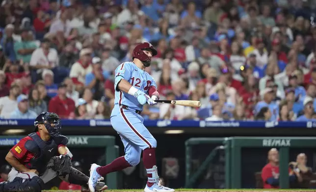 Philadelphia Phillies' Kyle Schwarber watches after hitting a two-run home run against Atlanta Braves pitcher Austin Cox during the fourth inning of a baseball game Thursday, Aug. 28, 2025, in Philadelphia. (AP Photo/Matt Slocum)