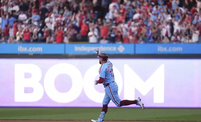 Philadelphia Phillies' Kyle Schwarber reacts after hitting a home run against Atlanta Braves pitcher Cal Quantrill during the first inning of a baseball game Thursday, Aug. 28, 2025, in Philadelphia. (AP Photo/Matt Slocum)