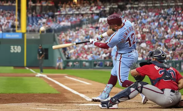 Philadelphia Phillies' Kyle Schwarber hits a home run against Atlanta Braves pitcher Cal Quantrill during the first inning of a baseball game Thursday, Aug. 28, 2025, in Philadelphia. (AP Photo/Matt Slocum)
