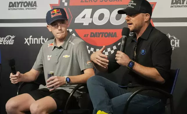 NASCAR driver Connor Zilisch, left, listens as Trackhouse Racing owner Justin Marks answers questions at an auto racing news conference at Daytona International Speedway, Saturday, Aug. 23, 2025, in Daytona Beach, Fla. (AP Photo/John Raoux)