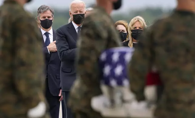 FILE - President Joe Biden, first lady Jill Biden, and Secretary of State Antony Blinken look on as as a carry team moves a transfer case with the remain of Marine Corps Cpl. Humberto A. Sanchez, 22, of Logansport, Ind., during a casualty return at Dover Air Force Base, Del., Aug. 29, 2021, for the 13 service members killed in the suicide bombing in Kabul, Afghanistan, on Aug. 26. (AP Photo/Carolyn Kaster, file)