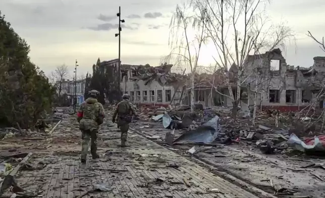 FILE - In this photo taken from video distributed by the Russian Defense Ministry Press Service on Thursday, March 13, 2025, Russian soldiers patrol an area in Sudzha, in the Kursk region of Russia, after it was taken over by Russian troops. (Russian Defense Ministry Press Service via AP, File)