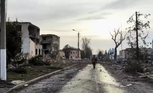 FILE - In this photo taken from video distributed by Russian Defense Ministry Press Service on Thursday, March 13, 2025, a Russian soldier patrols an area in Sudzha, the Kursk region of Russia after it was taken over by Russian troops. (Russian Defense Ministry Press Service via AP, File)