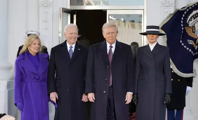 FILE - President-elect Donald Trump and Melania Trump are greeted by President Joe Biden and first lady Jill Biden, upon their arrival at the White House, Jan. 20, 2025, in Washington. (AP Photo/Alex Brandon, File)