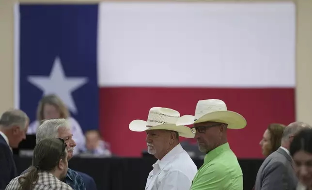 Attendees wait for a Senate and House Select Committees on Disaster Preparedness and Flooding public hearing to begin, in Kerrville, Texas, Thursday, July 31, 2025. (AP Photo/Eric Gay)