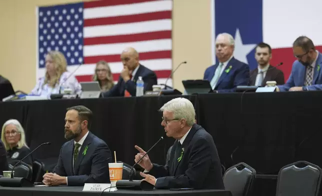 Texas Lt. Gov. Dan Patrick, center, speaks during a Senate and House Select Committees on Disaster Preparedness and Flooding public hearing in Kerrville, Texas, Thursday, July 31, 2025. (AP Photo/Eric Gay)