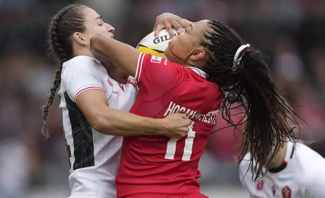 Asia Hogan-Rochester of Canada, right, is tackled by Jasmine Joyce-Butchers of Wales during the pool B match at the 2025 Women's Rugby World Cup between Canada and Wales, in Manchester, England, Saturday, Aug. 30, 2025. (AP Photo/Dave Shopland)