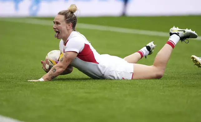 England's Megan Jones celebrates scoring their first try during the pool A match between England v Samoa, at the 2025 Women's Rugby World Cup, at Franklin's Gardens, Northampton, England, Saturday, Aug. 30, 2025. (Joe Giddens/PA via AP)