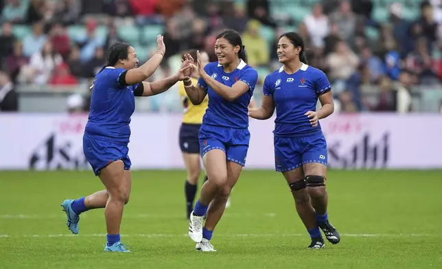 Samoa's Harmony Vatau, centre, celebrates scoring a penalty during the pool A match between England v Samoa, at the 2025 Women's Rugby World Cup, at Franklin's Gardens, Northampton, England, Saturday, Aug. 30, 2025. (Joe Giddens/PA via AP)