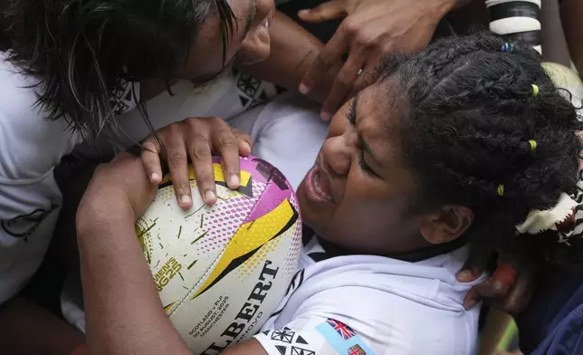 Loraini Adivereika Senivutu of Fiji reacts after scoring a try during the pool B match at the 2025 Women's Rugby World Cup between Scotland and Fiji, in Manchester, England, Saturday, Aug. 30, 2025. (AP Photo/Dave Shopland)