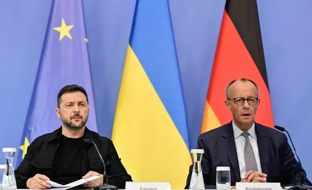 Ukrainian President Volodymyr Zelenskyy, left, and German Chancellor Friedrich Merz attend a video meeting of European leaders with US President Donald Trump on the Ukraine war in Berlin, Germany, Wednesday, Aug. 13, 2025, ahead of the summit between the US and Russian leaders. (John MacDougall/Pool Photo via AP)