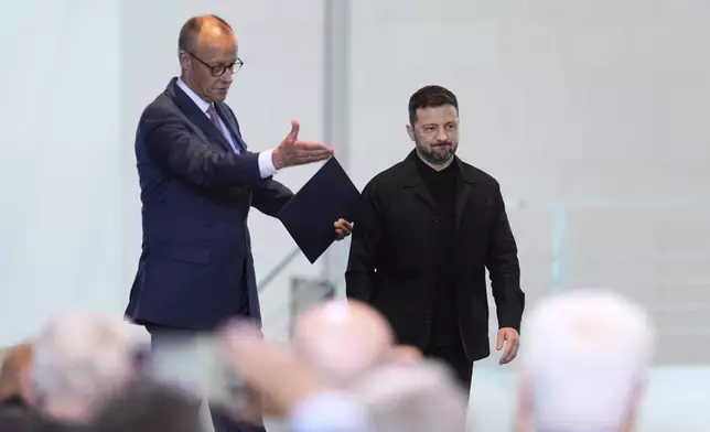 FILE -Germany's Chancellor Friedrich Merz, left, and Ukraine's President Volodymyr Zelenskyy arrive for a news conference at the chancellery in Berlin, Germany, May 28, 2025.(AP Photo/Markus Schreiber, File)