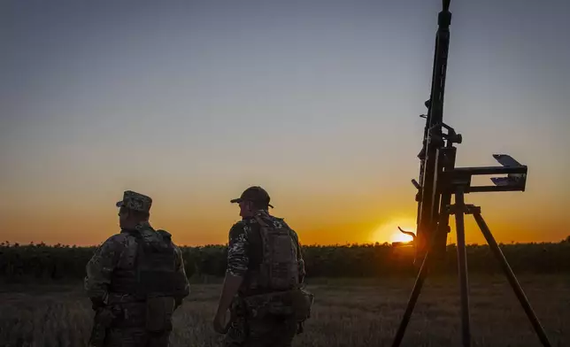 Ukrainian servicemen of the 15th Army Corps stand by an armed pickup truck during night duty in the Chernihiv region, Ukraine, late Tuesday, Aug. 12, 2025. (AP Photo/Dan Bashakov)