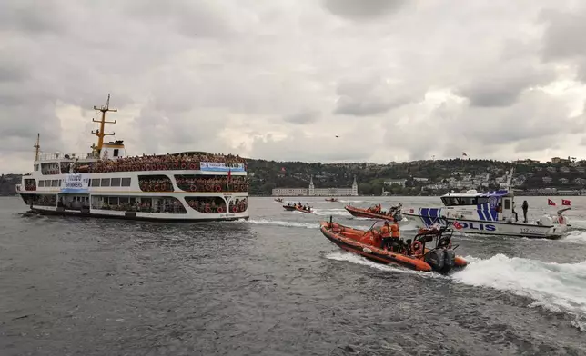 Competitors aboard a ferry heading to the start line of a 6.5-kilometer swimming race across the Bosphorus Strait, from the Asian side to the European side, in Istanbul, Turkey, Sunday, Aug. 24, 2025. (AP Photo/Khalil Hamra)