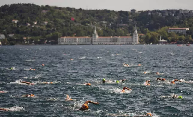Competitors take part in a 6.5 km swimming race across the Bosphorus Strait, from the Asian side to the European side, in Istanbul, Turkey, Sunday, Aug. 24, 2025. (AP Photo/Khalil Hamra)