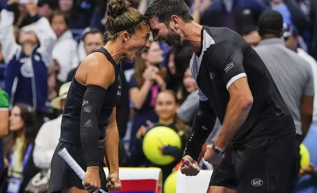Sara Errani, left, of Italy, and Andrea Vavassori, of Italy, celebrate after winning the mixed doubles semifinal at the U.S. Open tennis championships, Wednesday, Aug. 20, 2025, in New York. (AP Photo/Yuki Iwamura)