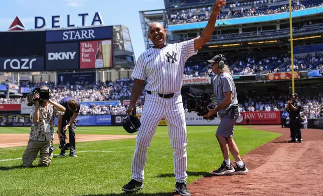 Former New York Yankees' Mariano Rivera (42) enters the Yankees Old-Timers' Day ceremony before a baseball game against the Houston Astros, Saturday, Aug. 9, 2025, in New York. (AP Photo/Yuki Iwamura)