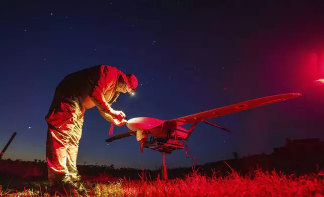 A Ukrainian National Guard serviceman of 3rd brigade, Spartan, prepares a Penguin UAV for flight near the frontline in Pokrovsk direction, Ukraine, Wednesday, Aug. 6, 2025. (AP Photo/Evgeniy Maloletka)