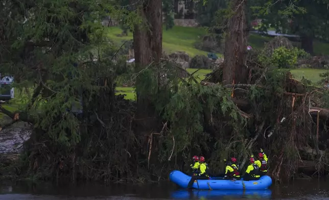 FILE - Rescue workers are seen a boat as they search for missing people near Camp Mystic along the Guadalupe River after a flash flood swept through the area, July 6, 2025, in Hunt, Texas. (AP Photo/Julio Cortez, file)