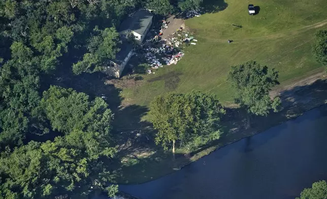 FILE - This aerial photo shows damage to Camp Mystic from flash floods along the Guadalupe River in Hunt, Texas, July 10, 2025. (AP Photo/Gerald Herbert, File)