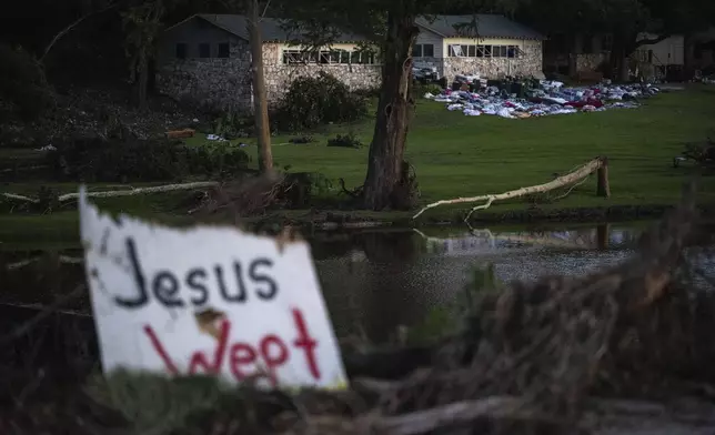 FILE - Camper's belongings sit outside one of Camp Mystic's cabins near the Guadalupe River after a flash flood swept through the area, July 7, 2025, in Hunt, Texas. (AP Photo/Eli Hartman, file)