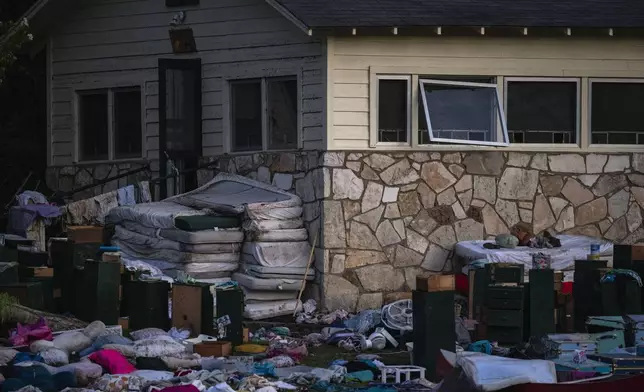 FILE - Camper's belongings sit outside one of Camp Mystic's cabins near the Guadalupe River, July 7, 2025, in Hunt, Texas, after a flash flood swept through the area. (AP Photo/Eli Hartman, file)
