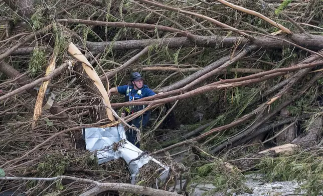 FILE - First responders from College Station Fire Department search along the banks of the Guadalupe River, as rescue efforts continue following extreme flooding, July 6, 2025, in Ingram, Texas. (AP Photo/Rodolfo Gonzalez, file)