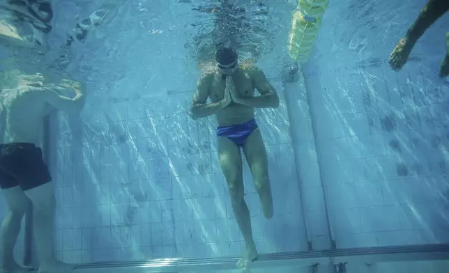 Ukrainian war veteran Pavlo Tovstyk rests during a training for a 6.5km swimming race across the Bosporus Strait, in Kyiv, Ukraine, Tuesday, Aug. 12, 2025. (AP Photo/Evgeniy Maloletka)