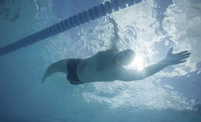 Ukrainian war veteran Oleksandr Dashko trains in a pool for an upcoming 6.5km swimming race across the Bosporus Strait, in Kyiv, Ukraine, Tuesday, Aug. 12, 2025. (AP Photo/Evgeniy Maloletka)