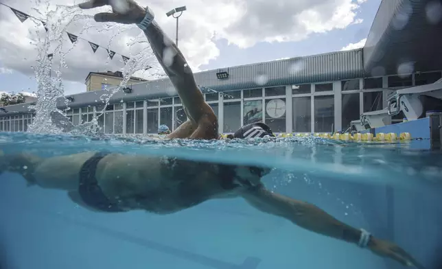Ukrainian war veteran Oleh Tserkovnyi trains in a pool in Kyiv, Ukraine, Tuesday, Aug. 12, 2025, for the upcoming 6.5km swimming race across the Bosporus Strait. (AP Photo/Evgeniy Maloletka)