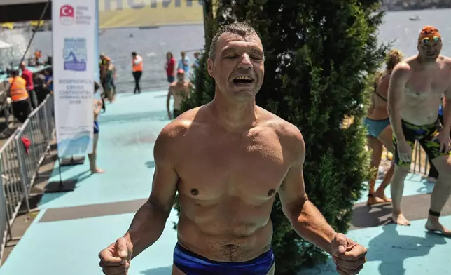 Ukrainian war veteran Pavlo Tovstyk reacts at the finish line after completing a 6.5km swimming race across the Bosporus Strait, from the Asian side to the European side, in Istanbul, Turkey, Sunday, Aug. 24, 2025. (AP Photo/Khalil Hamra)