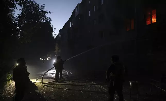 Rescue workers put out a fire at a residential building destroyed by a Russian air strike in Zaporizhzhia, Ukraine, Saturday, Aug. 30, 2025. (AP Photo/Kateryna Klochko)