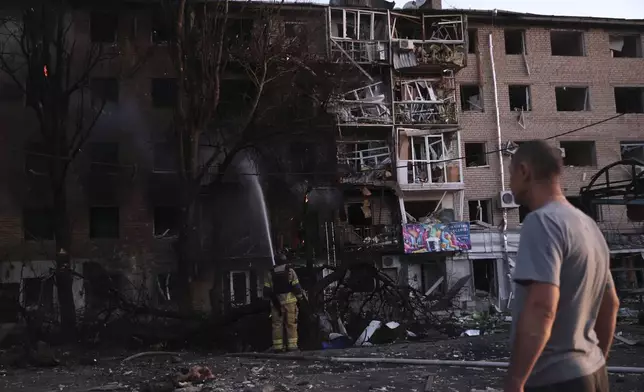A resident looks at his destroyed home following Russian air strike in Zaporizhzhia, Ukraine, Saturday, Aug. 30, 2025. (AP Photo/Kateryna Klochko)