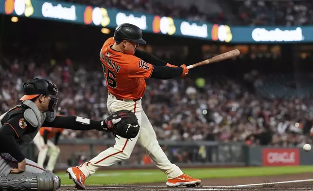 San Francisco Giants' Matt Chapman (26) hits an RBI single during the first inning of a baseball game against the Baltimore Orioles, Friday, Aug. 29, 2025, in San Francisco. (AP Photo/Godofredo A. Vásquez)