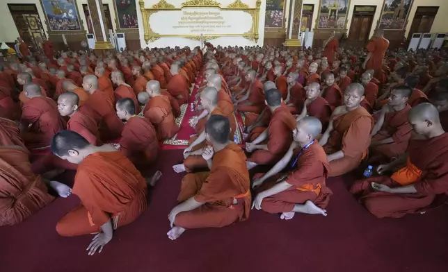 Cambodian Buddhist monks chant in a Buddhist pagoda of Wat Botumvotey as they organize a ceremony to offer prayers to the remains of the soldiers who sacrificed their lives in battles with Thai troops along the disputed border areas, in Phnom Penh, Cambodia, Friday, Aug. 8, 2025. (AP Photo/Heng Sinith)