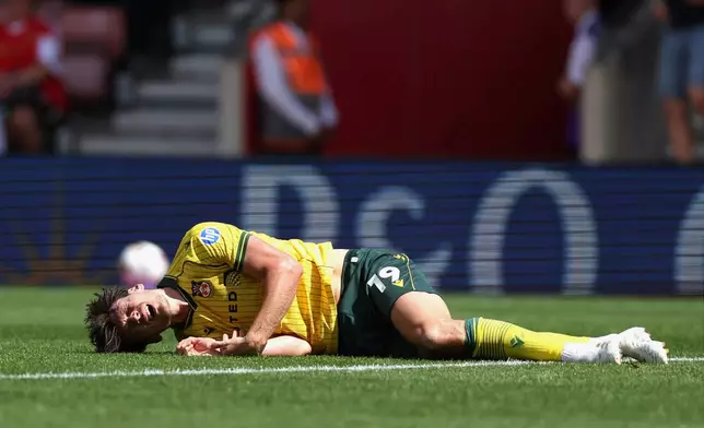 Wrexham's Kieffer Moore lays injured during their English Football League Championship soccer match against Southampton, at St Mary's Stadium, Southampton, England, Saturday, Aug. 9, 2025. (Steven Paston/PA via AP)