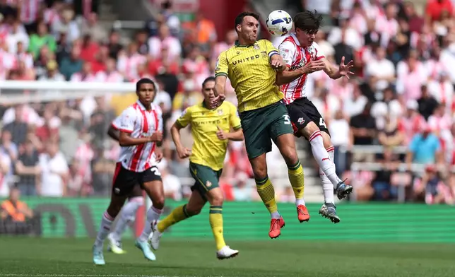 Wrexham's Matthew James and Southampton's Jay Robinson, right, vie for the ball during the English Football League Championship match at St Mary's Stadium, Southampton, England, Saturday, Aug. 9, 2025. (Steven Paston/PA via AP)